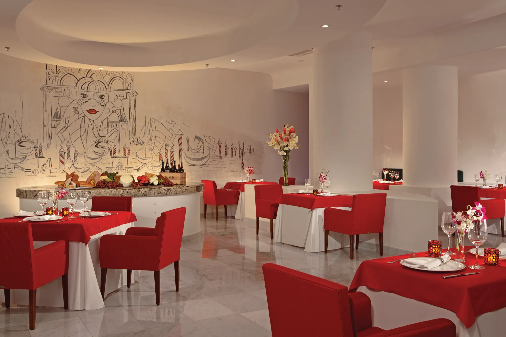 CinCin Italian restaurant at Secrets Huatulco Resort & Spa featuring modern trattoria-style décor, red-accented seating, and elegant Mediterranean dining ambiance.