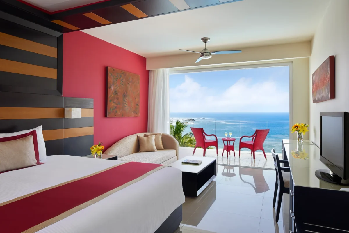 Preferred Club Junior Suite Ocean Front king bed with panoramic ocean views at Secrets Huatulco Resort & Spa.