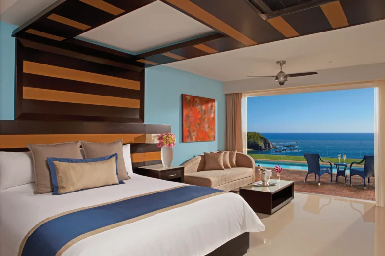 Preferred Club Junior Suite Swim Out with king bed and ocean view terrace at Secrets Huatulco Resort & Spa.