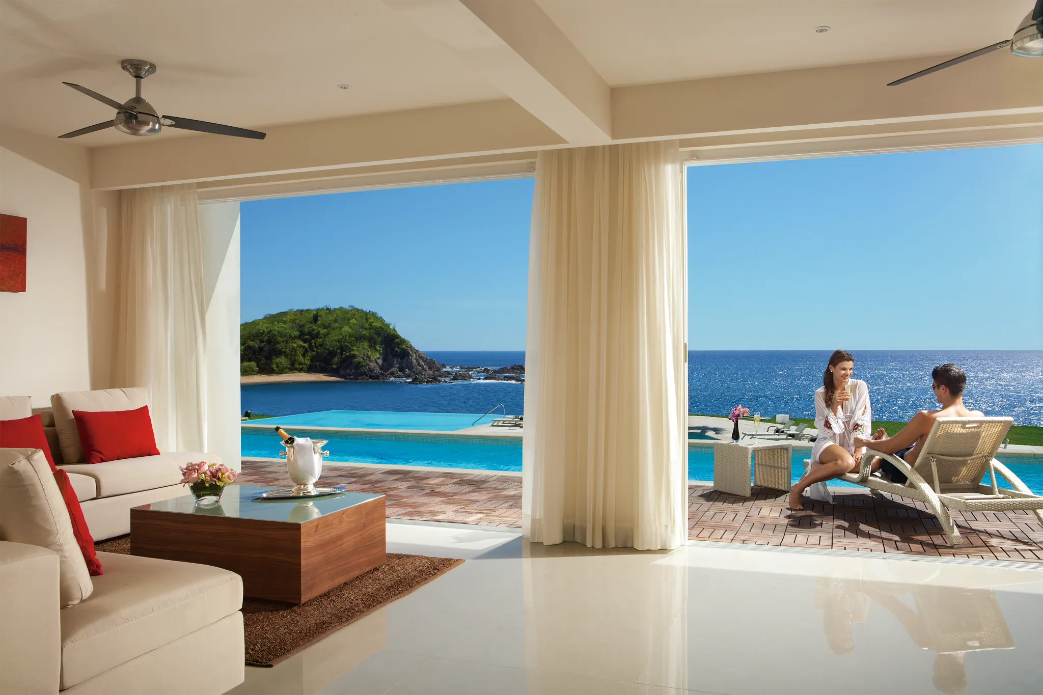 Couple relaxing in the swim-out pool from a Preferred Club One-Bedroom suite at Secrets Huatulco Resort & Spa.