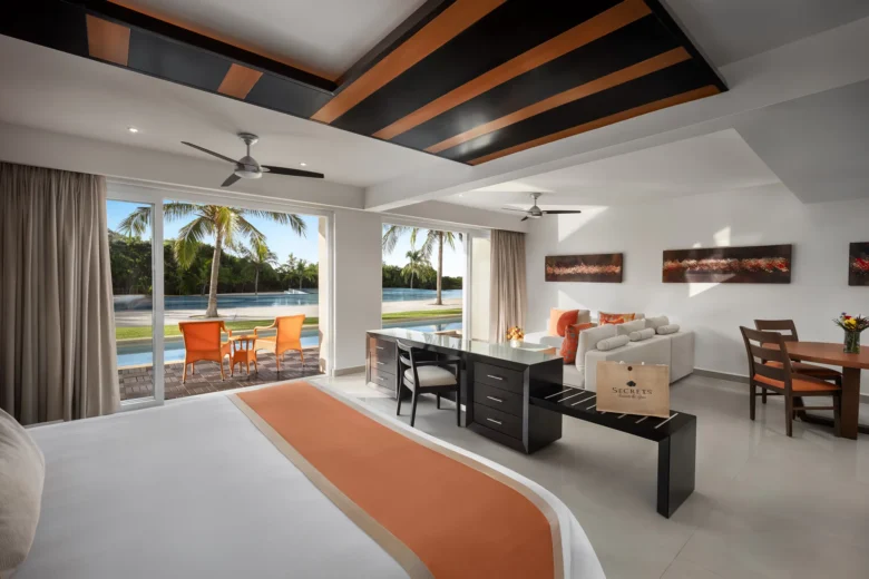 Preferred Club One-Bedroom Swim Out suite living area with private terrace and pool access at Secrets Huatulco Resort & Spa.