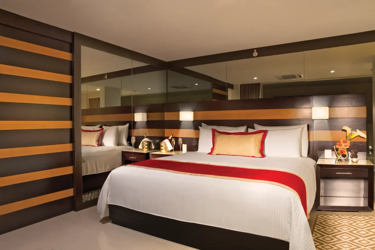 Preferred Club Two-Level Presidential Suite Swim Out bedroom with king bed at Secrets Huatulco Resort & Spa.