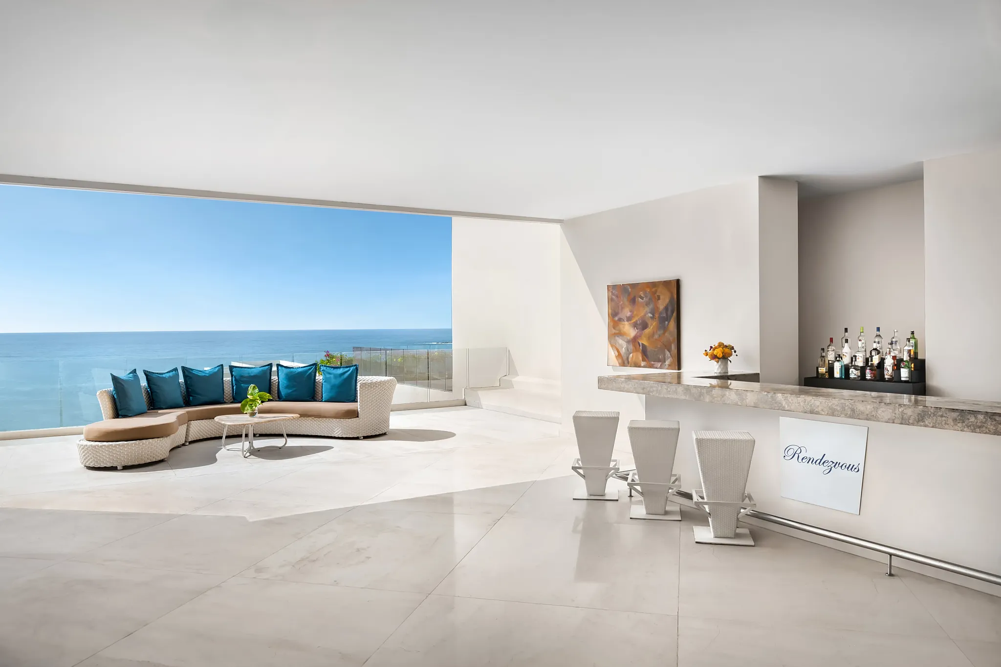 Rendezvous lobby bar at Secrets Huatulco Resort & Spa featuring chic modern décor, ocean-view lounge seating, and a sleek cocktail bar.