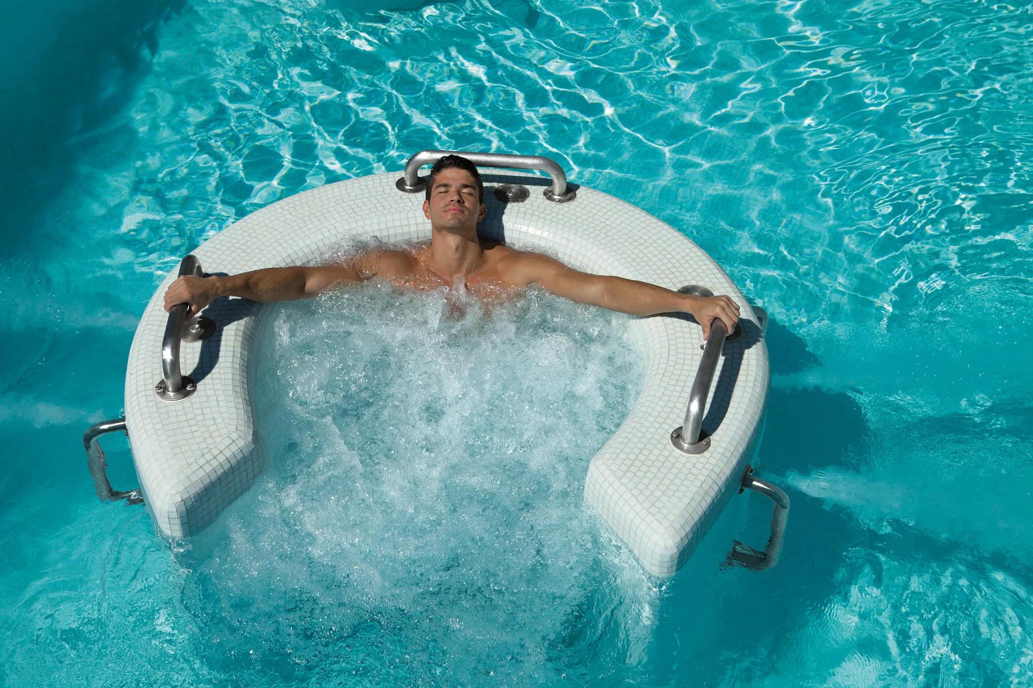 Guest enjoying a hydrotherapy whirlpool during the spa circuit at Secrets Huatulco Resort & Spa.