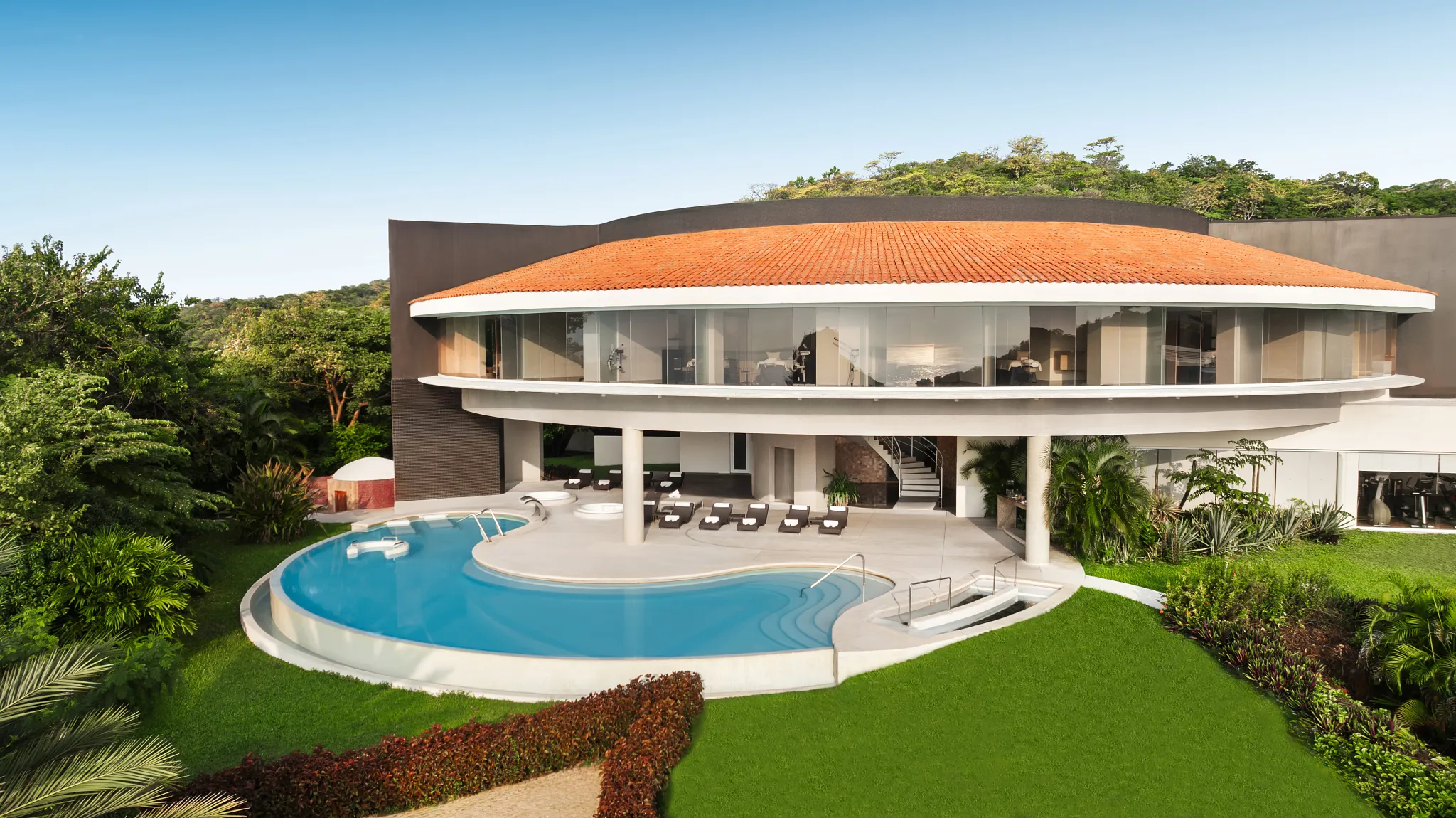 Exterior spa pool at Secrets Huatulco Resort & Spa surrounded by lush tropical landscaping, offering a serene adults-only relaxation experience.