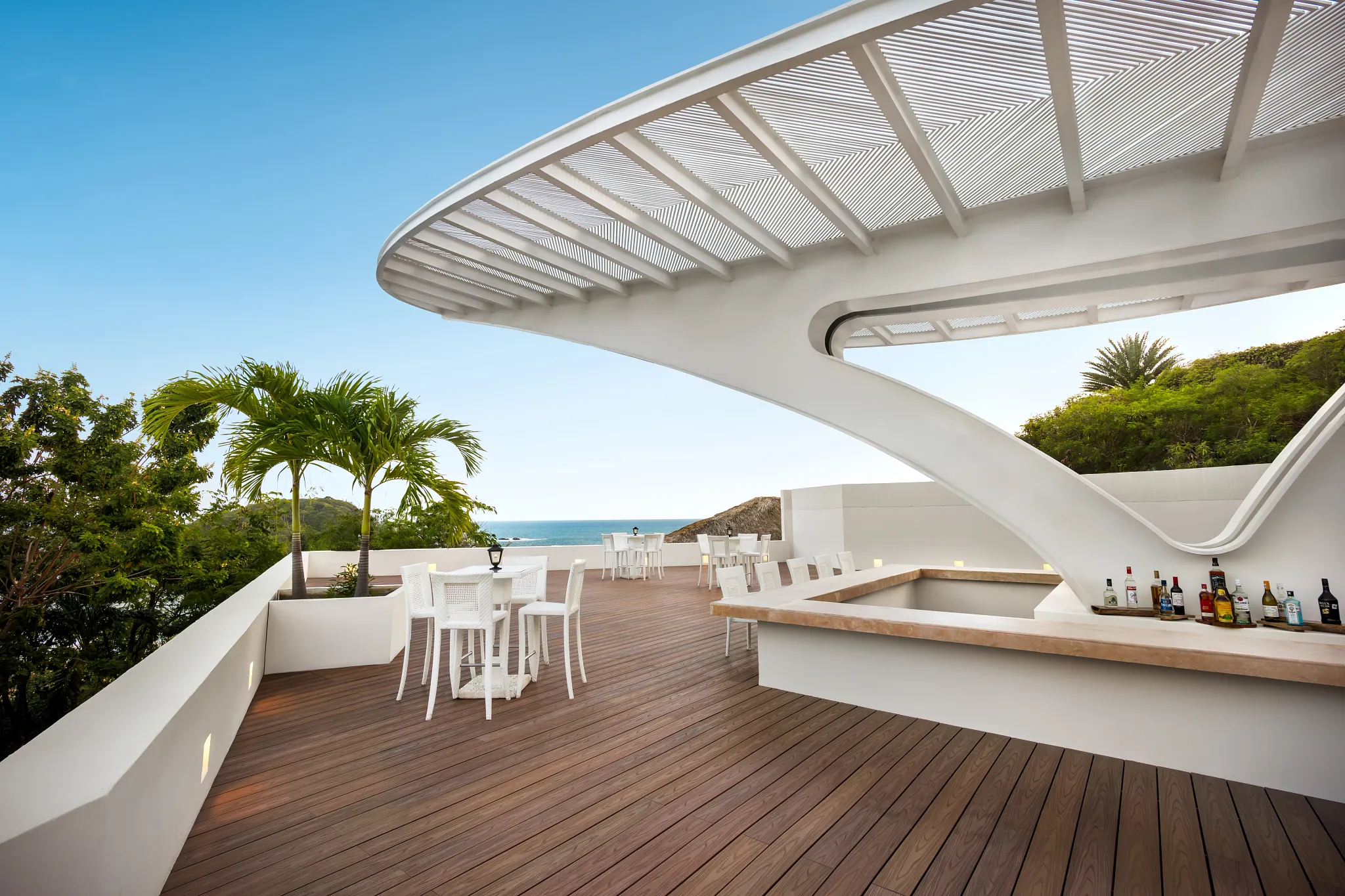 Sugar Reef poolside bar at Secrets Huatulco Resort & Spa featuring modern open-air design, tropical cocktails, and ocean-view terrace seating.